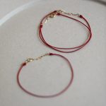 color: Gold + red rope